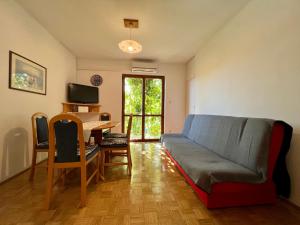 a living room with a couch and a desk at Vodice Center Apartments in Vodice