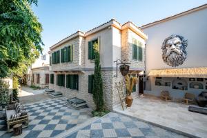 a house with a lion on the side of it at BİADA OTELLERİ in Bozcaada