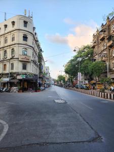 an empty street in a city with buildings at One Step Hostel in Mumbai