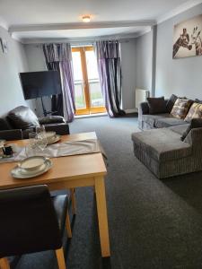 a living room with a table and a couch at 4 Goodman Lodge & 7 goodman Lodge in Thornton Heath