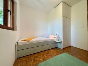a small bedroom with a bed and a cabinet at Vodice Center Apartments in Vodice