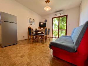 a kitchen and dining room with a table and a chair at Vodice Center Apartments in Vodice