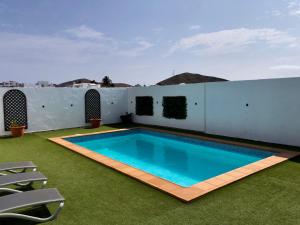 a swimming pool on the roof of a house at Villa Miriam in Tinajo