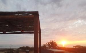 a sunset from the roof of a house at Tres Velas Surf in Celestino Gasca