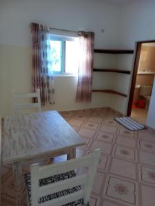 a room with a table and two chairs and a window at Rhino Apartment Watamu in Watamu