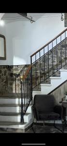 a chair sitting in front of a stair case at Hotel Maquis et Mer in Sari Solenzara