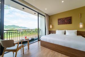 a bedroom with a bed and a large window at CAO BANG ECO HOUSE in Cao Bằng
