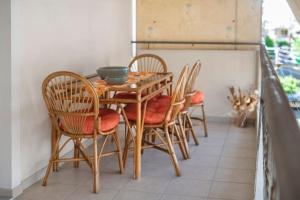 una mesa de madera con sillas y un tazón. en Lovely home apt with private parking next to Metro, en Atenas