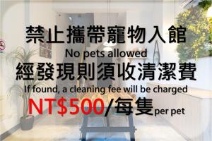 a sign in a window with the words no pets allowed at Bing Nong Homestay in Kaohsiung