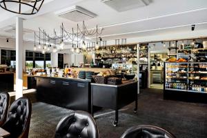 a restaurant with a counter and chairs in a room at Ringenäs Hotell & Konferens in Halmstad