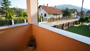 a view from the balcony of a house with a plant at President 034 Royal Spa in Arandelovac