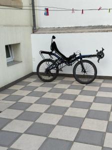a bike parked next to a white wall at Simple room in Luxembourg city in Luxembourg