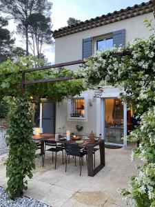 a patio with a table and chairs in front of a house at Mas provençal in Draguignan