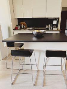 a kitchen with a table and two chairs at Scandinavian Desing Home 37 City Center in Kamppi in Helsinki