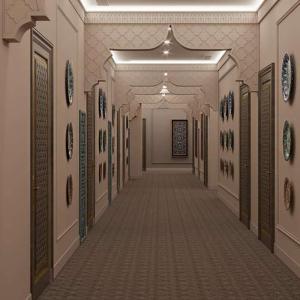 a hallway in a building with paintings on the walls at Reikartz Sote Tashkent in Tashkent