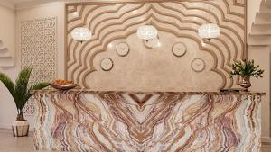 a table in a room with a wall at Reikartz Sote Tashkent in Tashkent