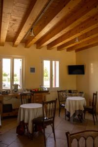 a dining room with tables and chairs and windows at Ranch borgo bella vita in Cavalier +65 photos