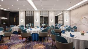 a meeting room with tables and chairs in a room at Crowne Plaza Shanghai by IHG in Shanghai +37 photos