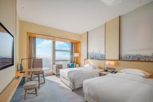 A bed or beds in a room at Four Points by Sheraton Wuhan, Jiangxia