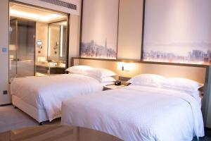 A bed or beds in a room at Four Points by Sheraton Wuhan, Jiangxia