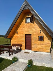 a wooden cabin with a wooden door and a patio at Family home MASA in Žabljak