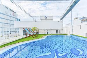 a swimming pool on the roof of a building at Annie Danang Hotel & Apartment in Danang