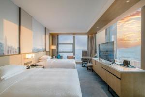A bed or beds in a room at Four Points by Sheraton Wuhan, Jiangxia