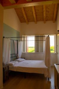 a bedroom with a canopy bed in a room with a window at Ranch borgo bella vita 