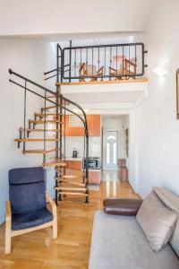 a living room with a spiral staircase in a house at Majka Apartments in Kotor