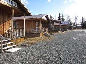 a building with a sign on it next to a street at All Seasons Campground in Ninilchik