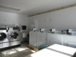 a laundry room with washers and dryers at All Seasons Campground in Ninilchik
