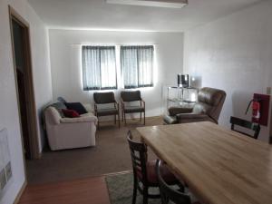 a living room with a table and chairs at All Seasons Campground in Ninilchik