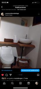 a bathroom with a toilet and a sink on a website at Habitación en Casa Cumbres del Lago in Puerto Varas