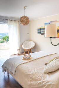 una camera da letto con un letto grande e una sedia di Grande villa de standing avec piscine à Sagone en Corse a Sagone