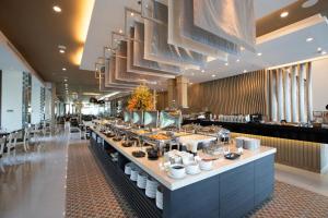 a buffet line in a restaurant with food on it at Kantary Hotel Korat in Nakhon Ratchasima