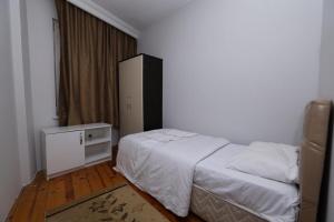 a bedroom with a bed and a dresser in it at Doğal apart in Trabzon