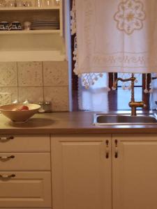 a kitchen with a sink and a bowl of fruit on the counter at Zeta's house Argalasti in Argalasti