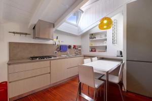 a kitchen with a table and chairs and a window at Penthouse in Città Alta - Bergamo in Bergamo