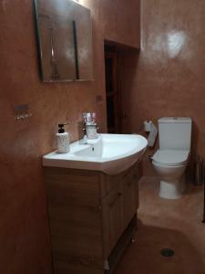 a bathroom with a white sink and a toilet at Zeta's house Argalasti in Argalasti