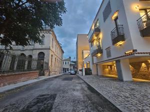 an empty street in a city with buildings at Rosetti One in Constanţa
