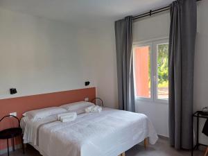 a bedroom with a bed with white sheets and a window at B&B NAR in Como