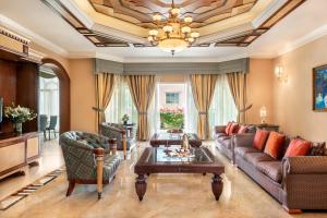 a living room with a couch and a table at Al Raha Beach Resort & Spa in Abu Dhabi