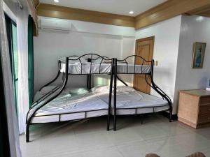 a bedroom with a bunk bed in a room at Canyon Cove by Lawton in Nasugbu