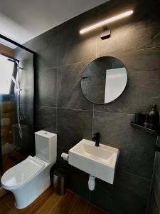 a bathroom with a sink and a toilet and a mirror at Sea La Vie #2 - Luxury Seaview apartment in Paphos City