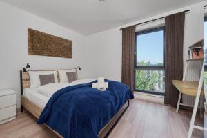 um quarto com uma cama, uma secretária e uma janela em City Center Mirrors Apartment with Parking by Renters em Breslávia