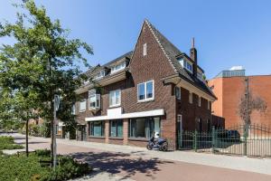 un edificio de ladrillo con una motocicleta estacionada frente a él en Hertog 1 Modern and perfectly located apartment en Eindhoven