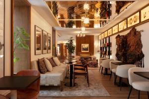 a lobby of a hotel with tables and chairs at Hotel Pulitzer Paris in Paris