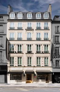 a large white building with lots of windows at Hotel Pulitzer Paris in Paris