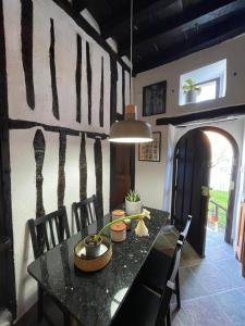 a dining room with a black table and chairs at LITTLE TOWER in Potes