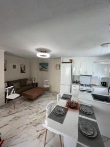 a kitchen and living room with a table and a refrigerator at Amarandos Studios Village Bliss in Fodele